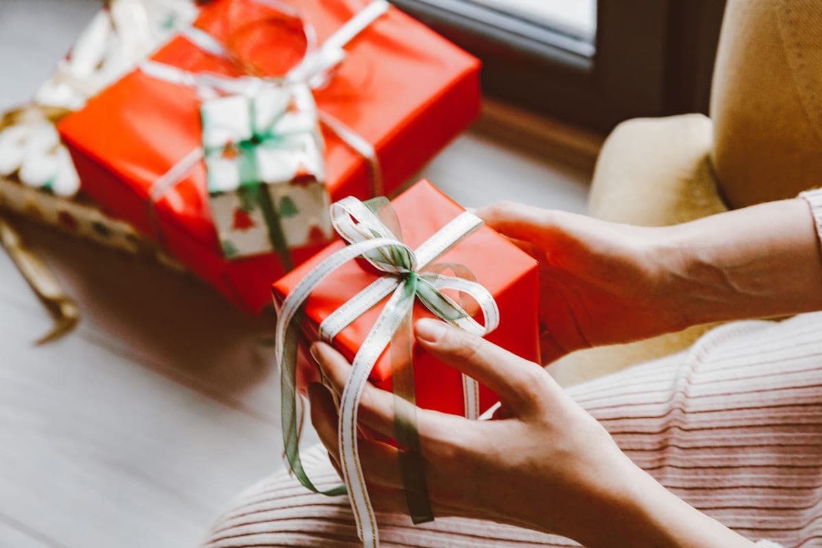 A person holding wrapped presents